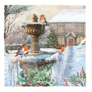 Christmas card showing a snowy winter scene with three robins perched on an ice-covered fountain, in front of a house with a decorated Christmas tree and wreath on the door.