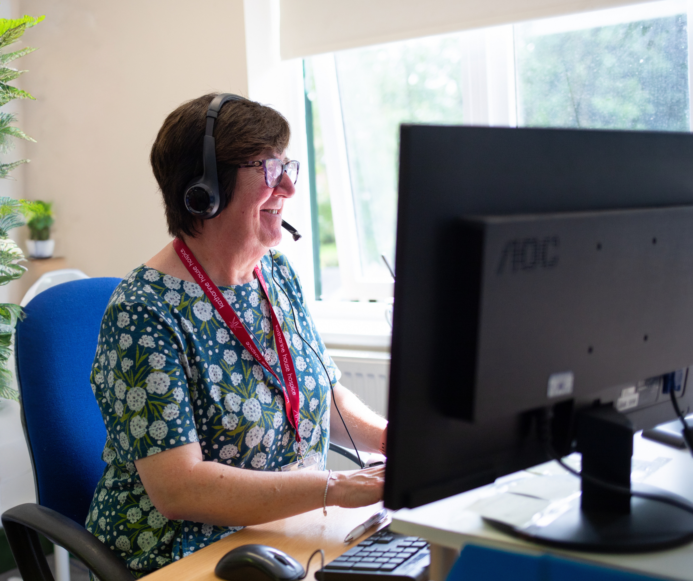 Someone from our Patient Pathway Team talking on the phone through her headset.